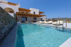 a swimming pool in front of a villa at Aegean Gem Villa with private pool in Paros in Mármara