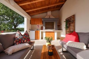 a living room with two couches and a table at Luxury villa with a swimming pool Poljica, Zadar - 22070 in Vrsi