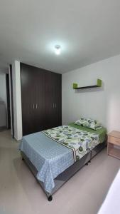 um quarto com uma cama e um armário de madeira em ¡Hermoso y cómodo apartamento! em Ibagué