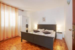 a bedroom with a large bed with two pillows on it at Apartments by the sea Pirovac, Sibenik - 6447 in Pirovac