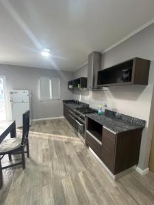 a kitchen with a stove and a counter top at Casa Náutico con estacionamiento privado in Río Gallegos