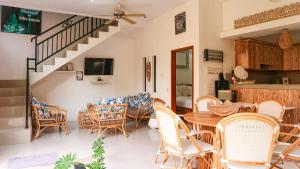 a living room with a table and chairs at Villa Aniela in Legian