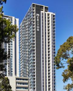 a tall building with the word avalon on it at Meriton Suites Chatswood in Sydney