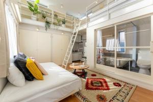 a small room with a white couch and a bathroom at M'sHouse in Tokyo