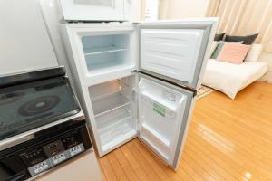 a refrigerator with its door open in a kitchen at M'sHouse in Tokyo