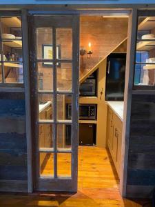 a kitchen with a sliding glass door in a house at the farmhouse suite at gallatin farmstead in Red Hook