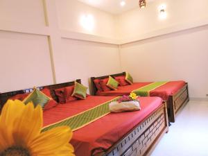 two beds in a room with a sunflower at Kanna Garden by Bodhi Bungalows in Kolli Hills