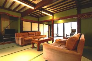 salon z kanapami, stołem i telewizorem w obiekcie Hanamizuki w mieście Yamanakako