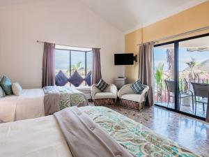 a hotel room with two beds and a balcony at Marina View Villas in Cabo San Lucas