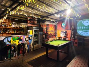 a room with a pool table and a bar at Showbiz Hostel in Yangshuo