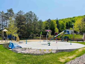 a park with a playground with a slide at LAÖ Lodge Tremblant - VIEW in Mont-Tremblant
