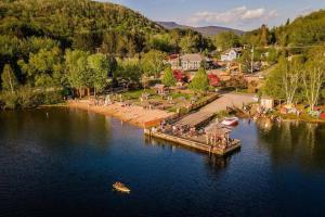 a group of people on a dock on a lake at LAÖ Lodge Tremblant - VIEW in Mont-Tremblant