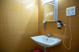 a bathroom with a sink and a mirror at Ronne's Staycation in Goa in Calangute