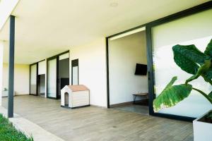 a row of windows on a building with a dog house at Luxury Villa Cerca Cali - Jamundi in Jamundí