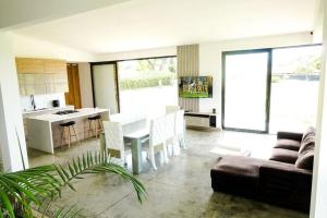 a kitchen and living room with a table and a couch at Luxury Villa Cerca Cali - Jamundi in Jamundí