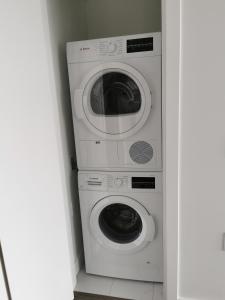 - deux lave-linge et un lave-linge/sèche-linge dans une pièce dans l'établissement Richmond center apartment, à Richmond