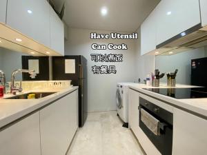 a kitchen with a sink and a washing machine at Vortex Premium Suites KLCC by SCHIEN in Kuala Lumpur