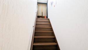 a staircase in a room with a stair case at USJ 2 stops, Umeda&Dotonbori 8mins, Ninja Style SV1 in Osaka