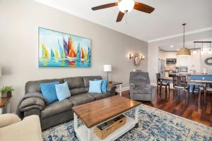 a living room with a couch and a table at Marina Retreat in Saint Simons Island