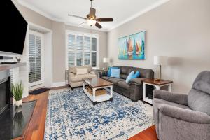 a living room with a couch and a tv at Marina Retreat in Saint Simons Island