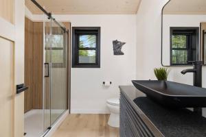 a bathroom with a black sink on a counter at Cuyuna Adventure Cabin: Solo Stove - On Bike Trail in Crosby