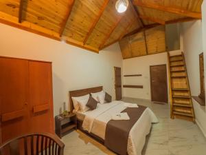 a bedroom with a large bed and wooden ceilings at The Mount View Single Tree Hotel in Nuwara Eliya
