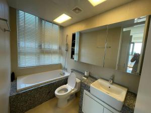 a bathroom with a sink and a toilet and a mirror at Starlake Daewoo Deluxe Apartment Managed by Anstay in Hanoi