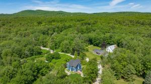 an aerial view of a house in the middle of a forest at The Blueberry House - Spacious, Family & Pet-Friendly Retreat near Sebago Lake in North Sebago