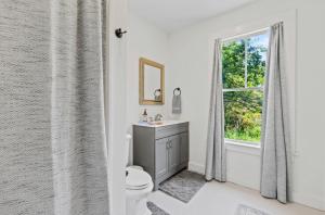 a bathroom with a toilet and a window at The Blueberry House - Spacious, Family & Pet-Friendly Retreat near Sebago Lake in North Sebago +51 photos