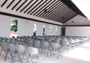 a large room with rows of chairs in it at Naya Matahora Island Resort in Longga
