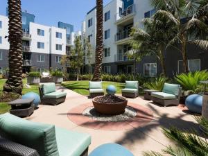 a courtyard with chairs and a fountain in front of a building at Lux Playa Vista 2 BDRM Condo in Los Angeles