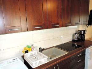 a kitchen with a sink and wooden cabinets at Holiday home in a quiet location in Borzyslawiec 