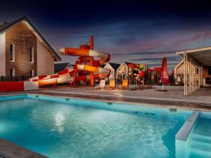a pool with a slide and a water park at Luxury holiday homes, swimming pool, Sarbinowo in Sarbinowo