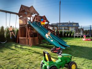 a park with a playground with a slide at Luxury holiday homes, swimming pool, Sarbinowo in Sarbinowo