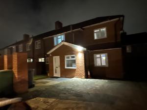 an empty parking lot in front of a building at night at 3rd Studio Flat For Family Enjoyment With Private Toilet and Bathroom 134 Keedonwood Road Bromley in Bromley