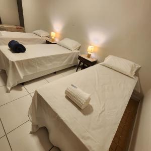 two beds in a hotel room with a toothbrush on a table at CASA IMPERIAL HOTEL POUSADA in São Luís