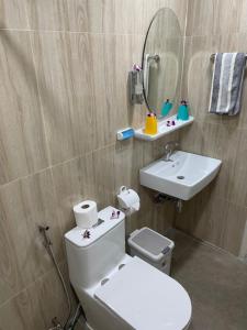 a bathroom with a toilet and a sink and a mirror at My Home in Patong Beach