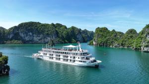 a cruise ship in a river with limestone cliffs at Paradise Grand Cruise - Lan Ha Bay in Ha Long