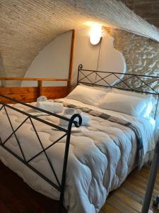 a bedroom with a bed with a metal frame at CasaNella in Lanciano