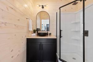 a bathroom with a sink and a shower at *Tiny House Luxury Getaway: Solo Stove, Adventure* in Ironton