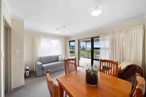 a living room with a table and a couch at Apartment 1 in Auckland +46 photos