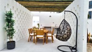 a patio with a table and chairs and a potted plant at Bello departamento en Bahia Inglesa in Bahia Inglesa