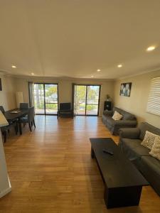 a living room with a couch and a table at Cowell Townhouse apartments in Cowell