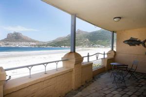 a balcony with a view of the beach at On the Beach in Hout Bay
