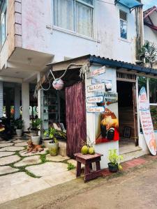 a dog laying in front of a building at Beach Paradise in Matara