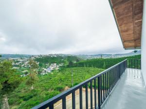 a balcony with a view of a city at The Mount View Single Tree Hotel in Nuwara Eliya