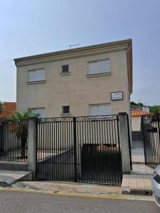 a building with a gate in front of it at Apto Residencial Monte Carlo em São Roque 01 in São Roque