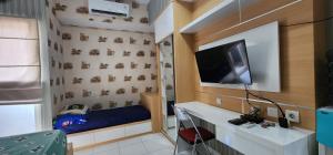 a small room with a tv on a wall at Apartemen Menara One Surakarta by Cariapartemen-id in Sukoharjo