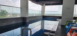 a swimming pool in a building with windows at Apartemen Menara One Surakarta by Cariapartemen-id in Sukoharjo