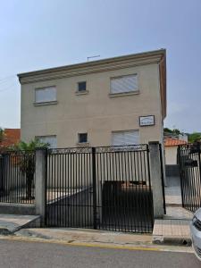 a building with a gate in front of it at Residencial 04 Monte Carlo em São Roque in São Roque